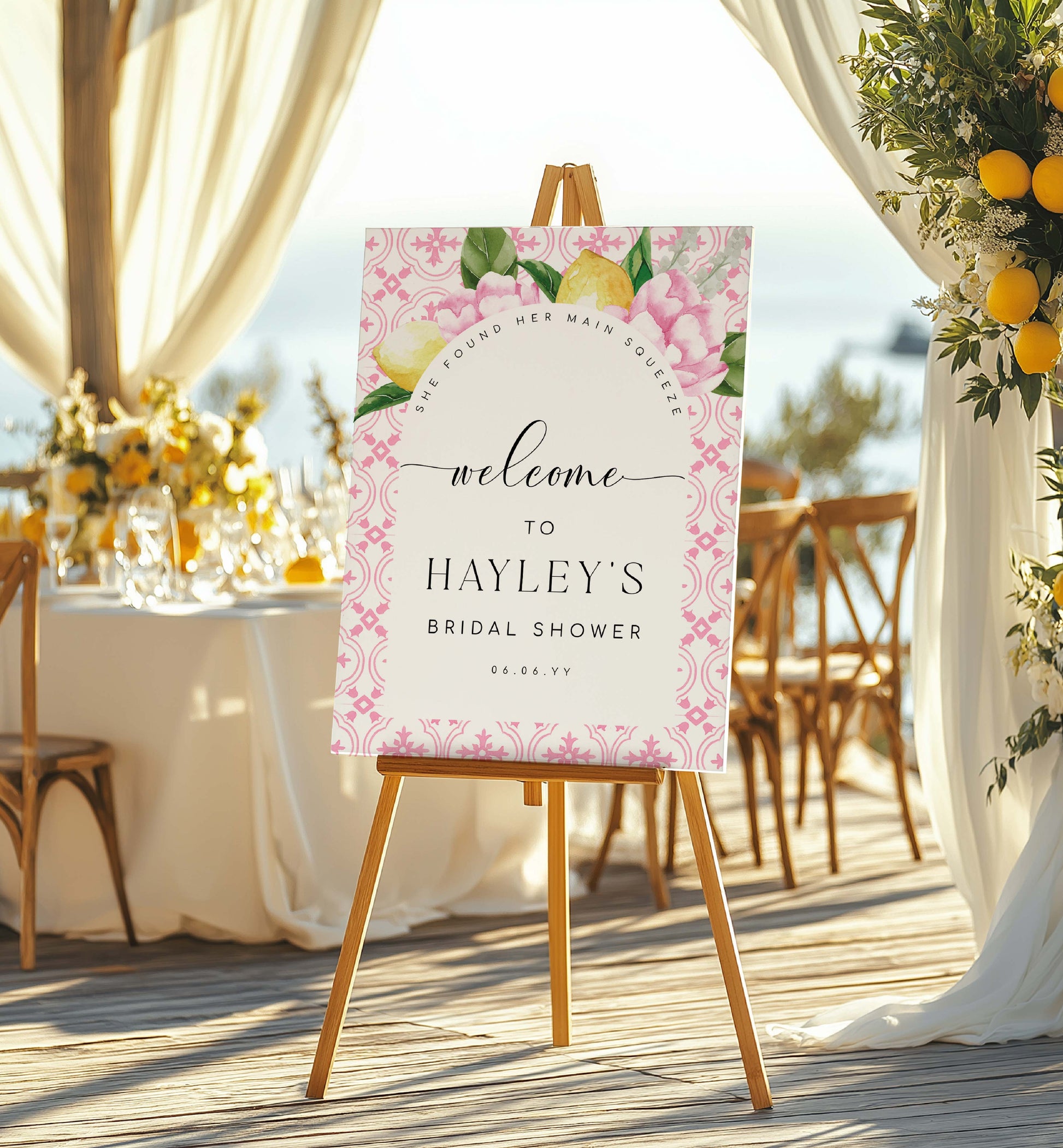Welcome sign for Hayley's bridal shower with floral design on an easel outdoors.