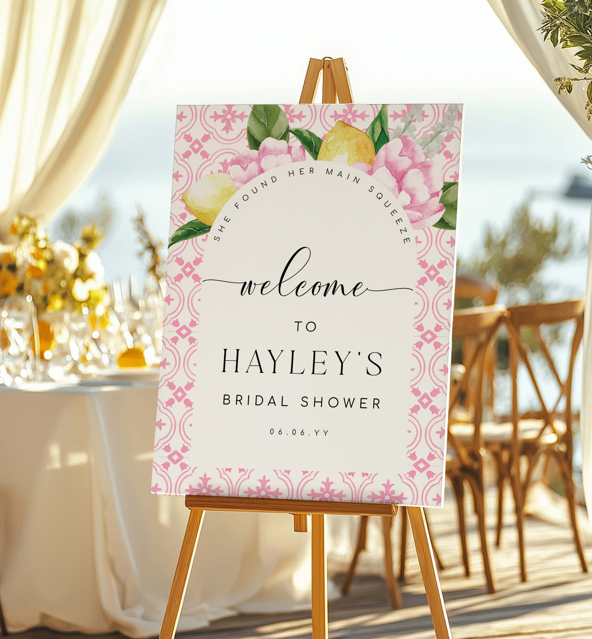 Welcome sign for Hayley's bridal shower with floral design on an easel outdoors.