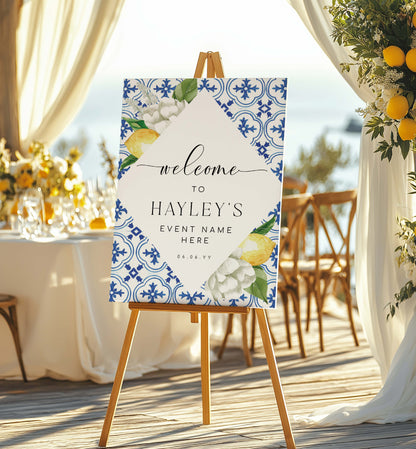 Decorative welcome sign on an easel with floral and lemon design, set outdoors. Mediterranean Blue Tile Lemons Wedding Welcome Sign Template, Printable Capri Lemons Wedding Sign, Bridal Shower Welcome Sign, The Med