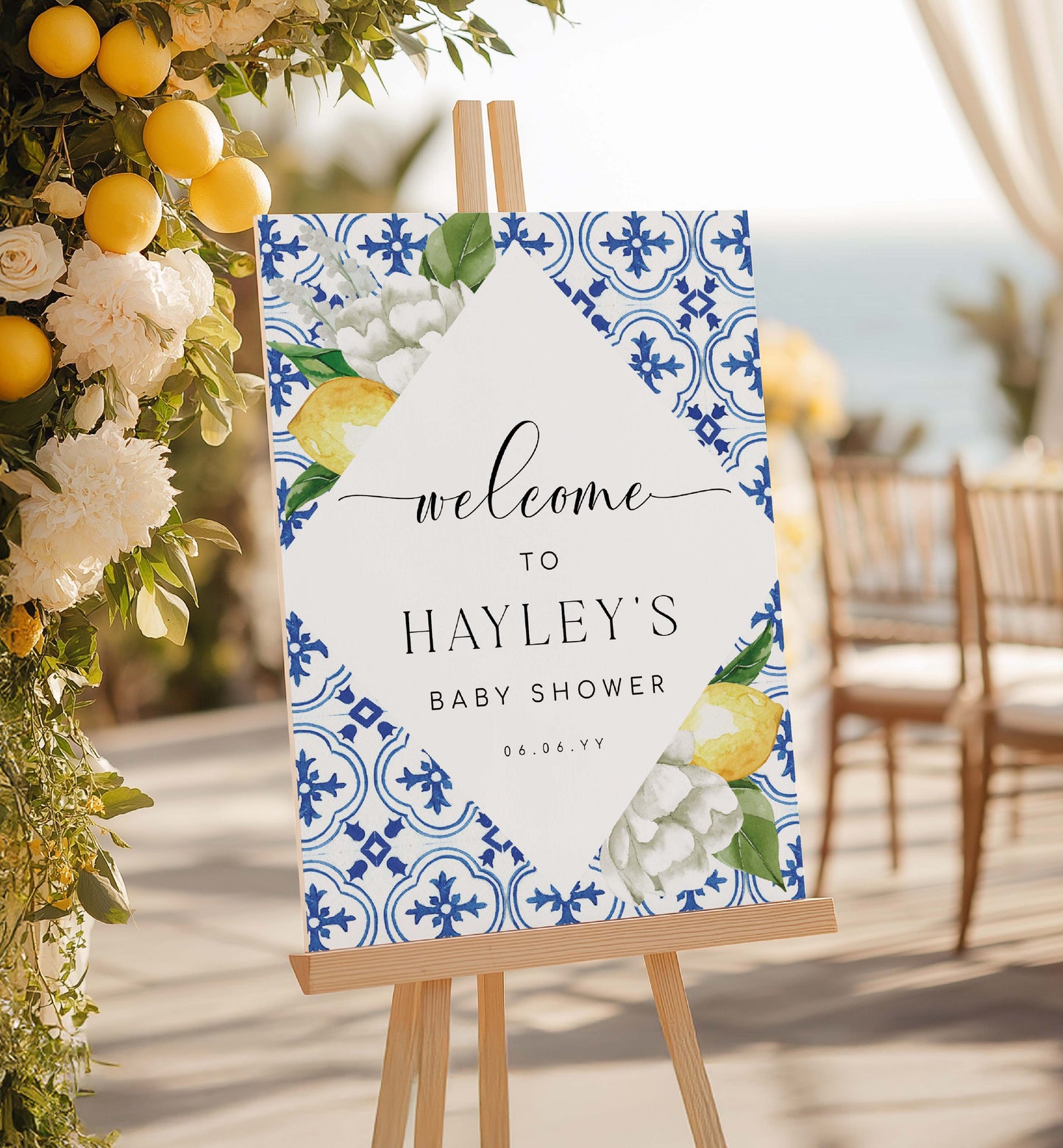 Baby shower welcome sign with floral and lemon design on an easel, surrounded by decorative flowers and lemons. Mediterranean Blue Tile Lemons Wedding Welcome Sign Template, Printable Capri Lemons Wedding Sign, Bridal Shower Welcome Sign, The Med